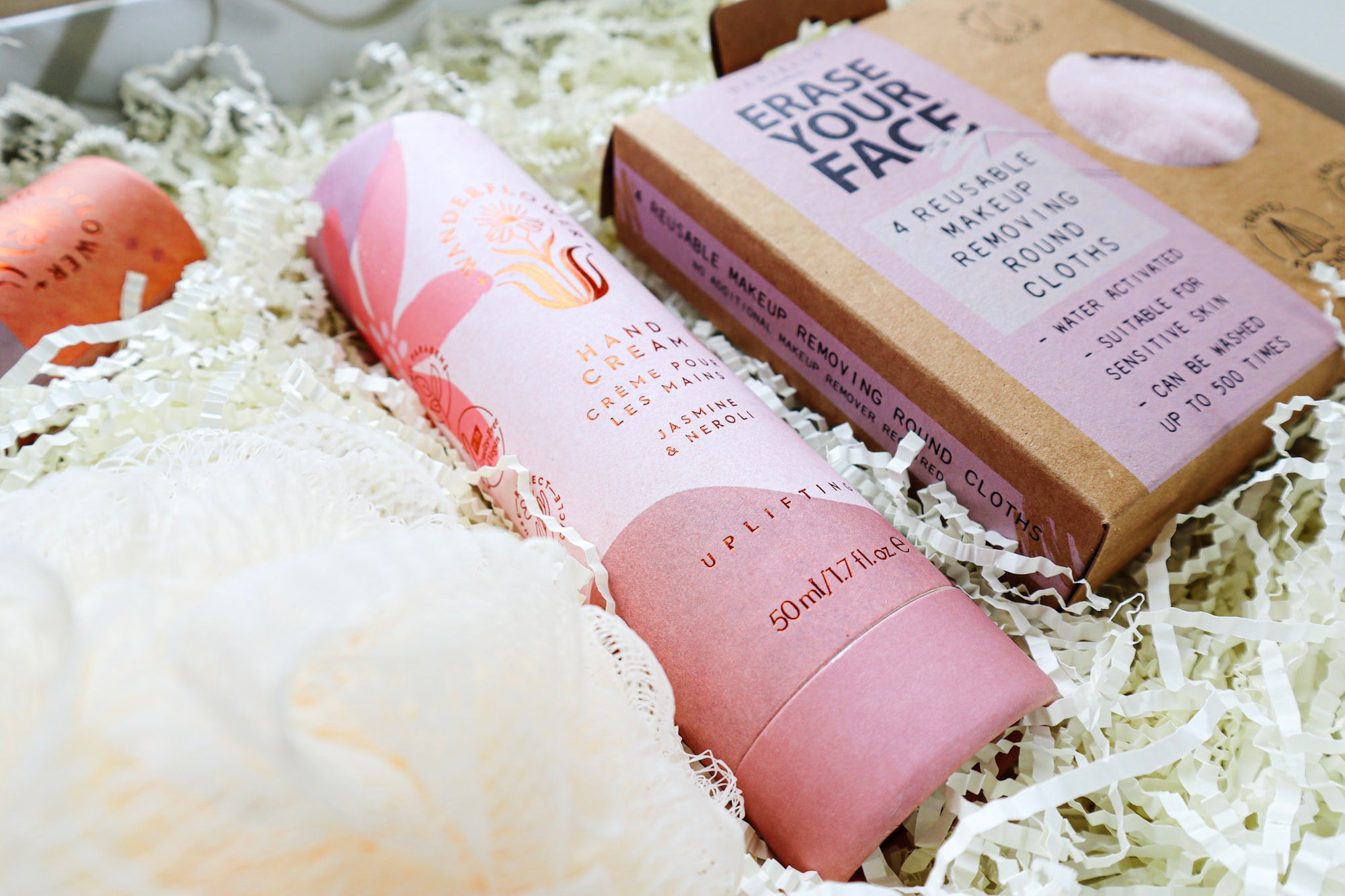 Close up of Wanderflower Hand Cream and a box of Erase Your Face Reusable Make Up Removing Round Cloths